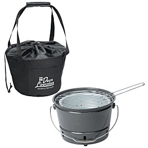 Gray bucket-shaped charcoal grill with black branded cover