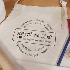 Chefs apron on counter with baking utensils